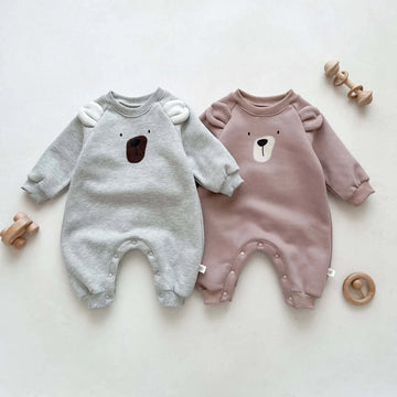 Image of cosy fleece baby onesie with bear ears, perfect for winter comfort. Shop now at OleOle.