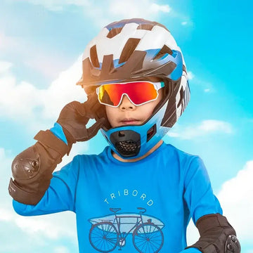 Child wearing polarized sports sunglasses and protective gear, ready for outdoor adventure.