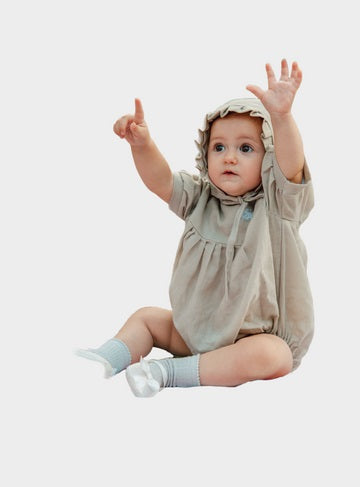 Image of a Cuddly Baby Girl wearing a hooded ruffle onesie - it is used at OleOle Baby Girl Clothes Collection Page