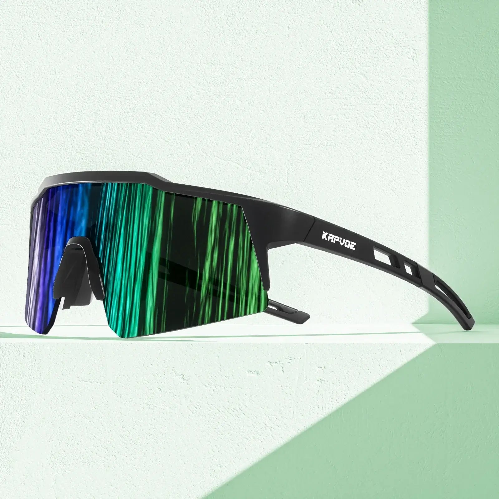 Kids polarized sports goggles with vibrant green and blue mirrored lenses on a light background.