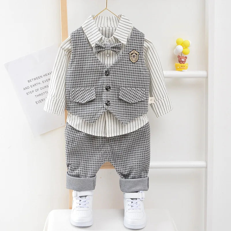 Children's formal outfit with vest, shirt, and pants on a hanger against a white background.