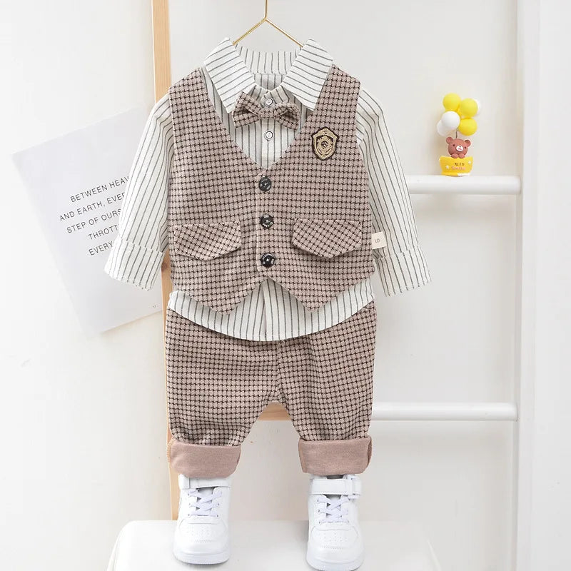 Children's outfit with checkered vest and pants on a hanger against a white background