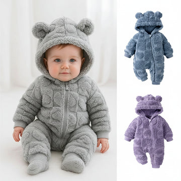 Baby in a gray fleece romper with bear ears, surrounded by additional rompers in blue and purple.