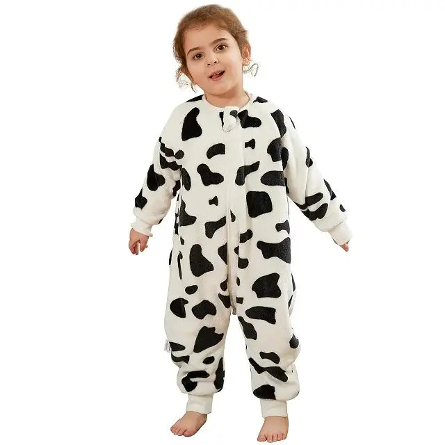 Cute child wearing a cow-patterned flannel onesie sleepsack, perfect for cozy and warm sleep.