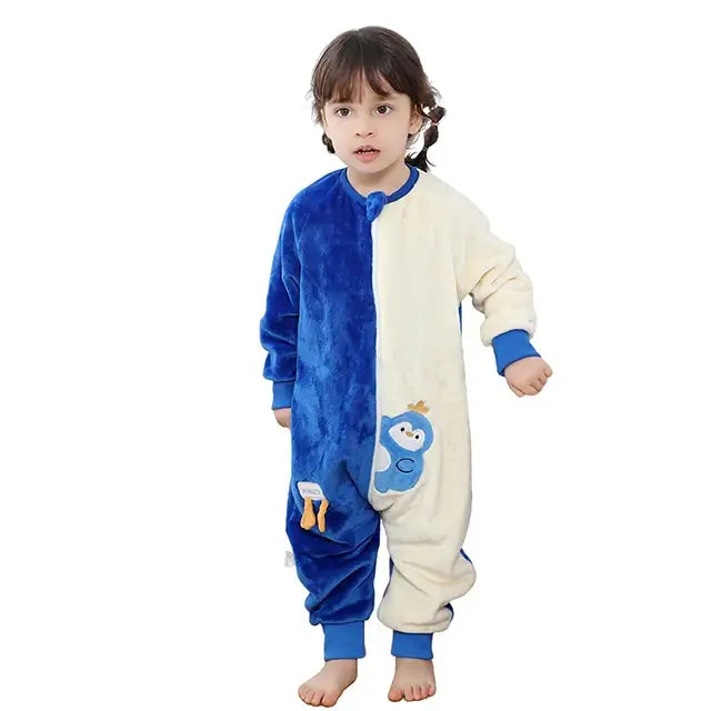 Child wearing a cozy blue and white flannel onesie with a cartoon penguin design, perfect for sleep or play.