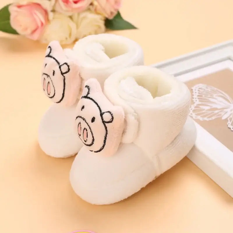 Anime design winter shoes for newborns, plush warmth, soft cloth sole, winter protection, suitable for baby aged 0-18 months.