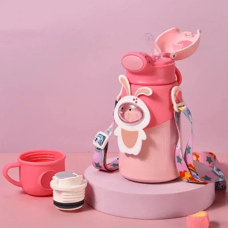 Kids thermos water bottle with playful bunny design, pink color, and colorful strap, ideal for hydration on-the-go.