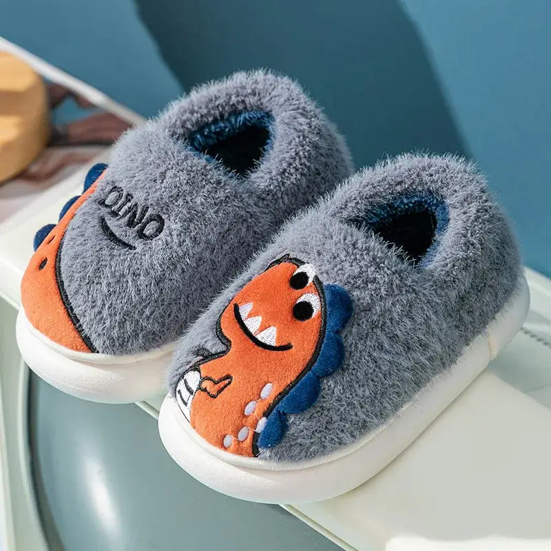 Kids winter slippers featuring plush cartoon dino design, perfect for toddlers and indoor adventures.