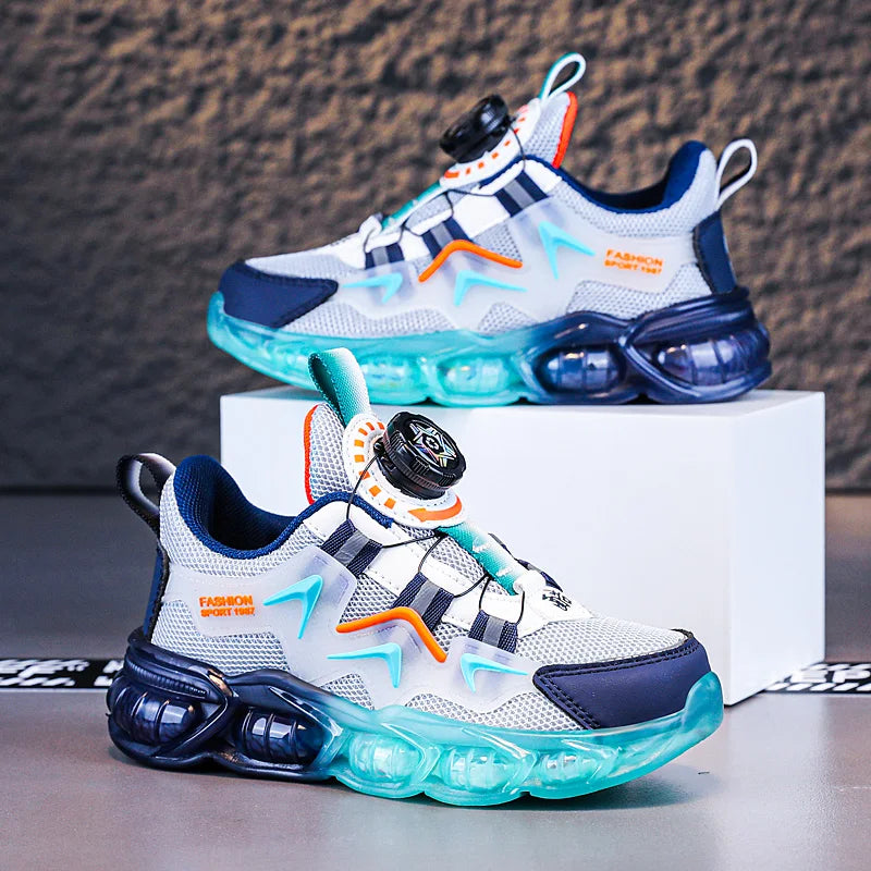 Colorful sneakers with blue and green sole on a gray surface