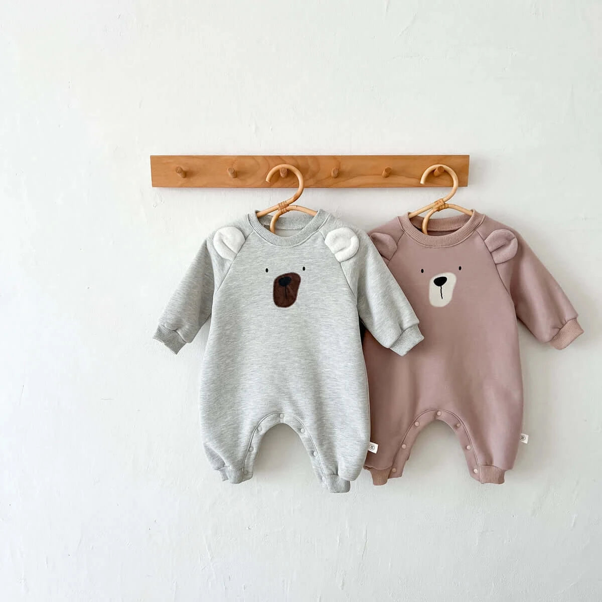 Image of cosy fleece baby onesie with bear ears, perfect for winter comfort. Shop now at OleOle.