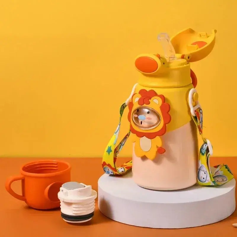 Kids thermos water bottle with lion design and straw, perfect for hydration and fun, surrounded by colorful accessories.