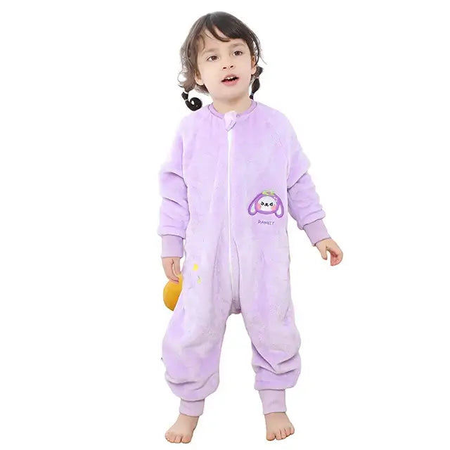 Child in a cozy purple flannel onesie sleepsack with cute cartoon design, perfect for warm and comfy sleep.