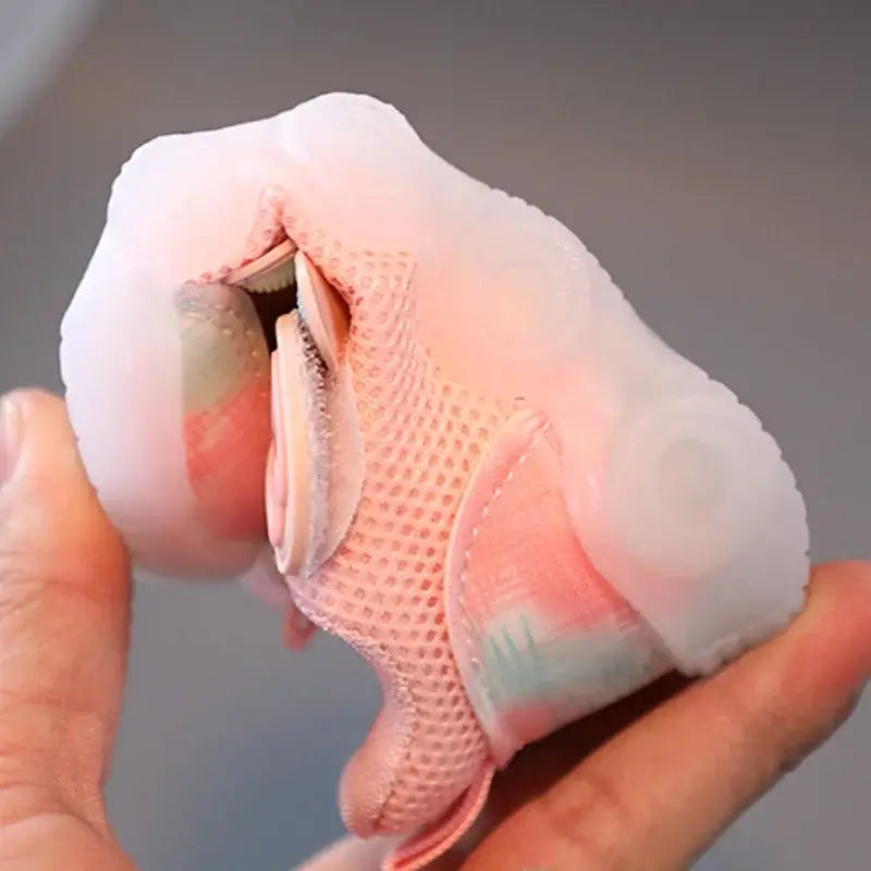 Close-up of pink breathable shoes with lights for kids, showcasing the mesh design and LED features.