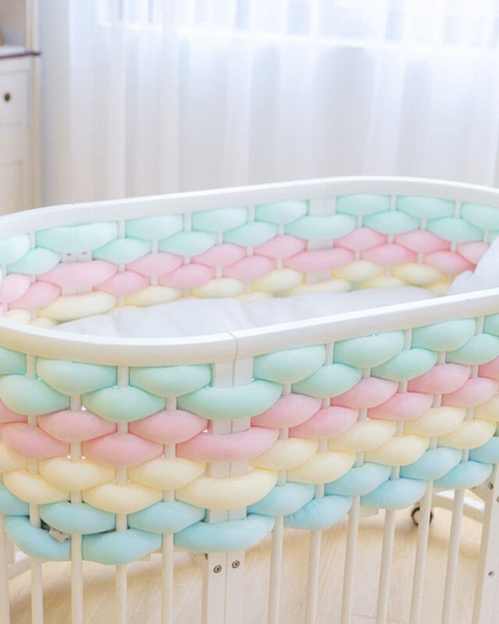 Image of multi-colour braided bumpers decoring around the baby cot are available on OleOle - shop now