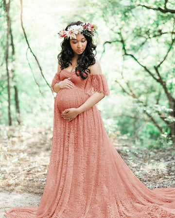 Image of a pregnant woman posing for photoshoot with a pink maternity dress is on sale at OleOle-Shop Now