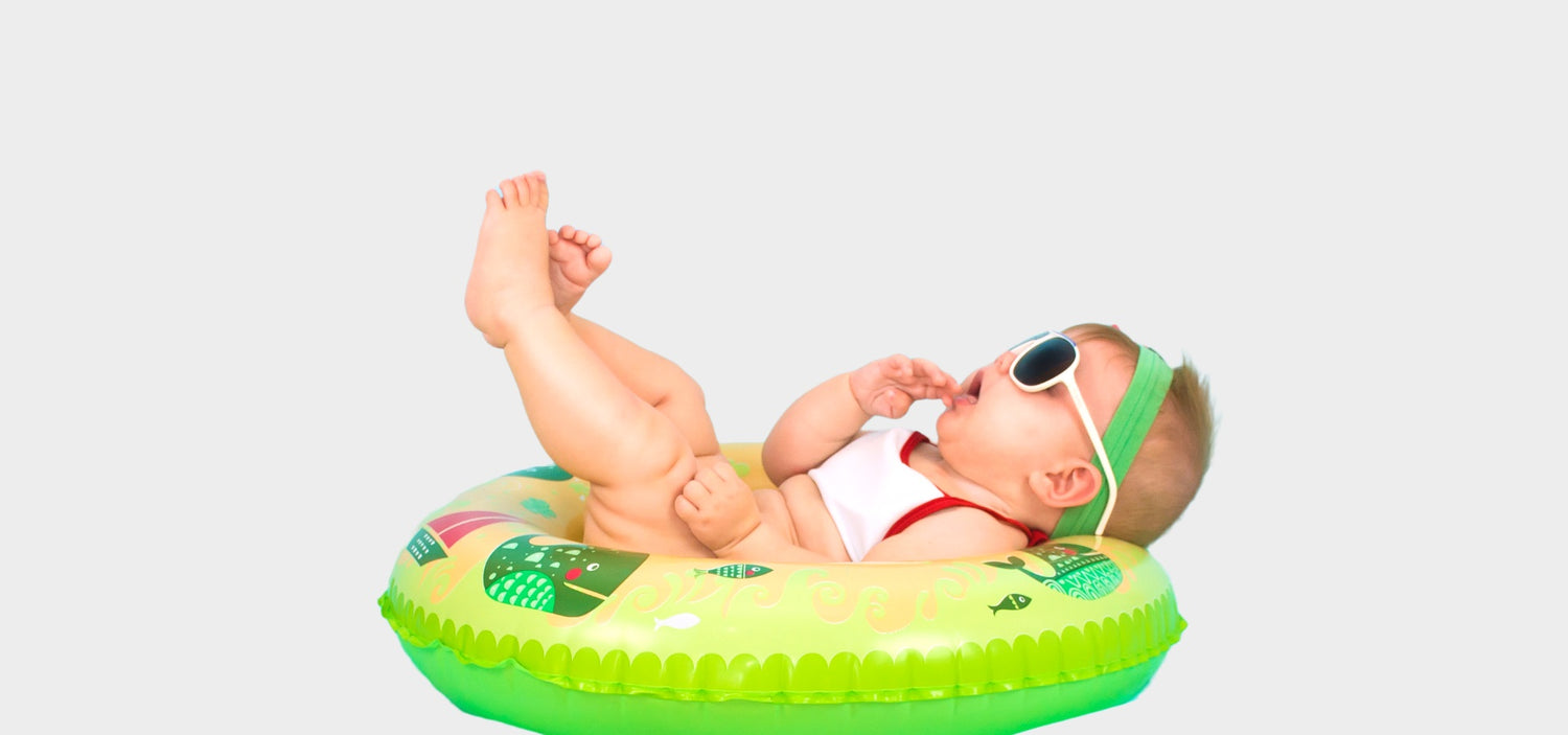 Image of a baby enjoying floats waring a cute sunglass - the image used on OleOle Home Page for Adorable baby accessories - hats, bibs, and more, adding style and comfort to your little one's ensemble
