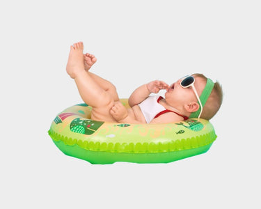 Image of a baby enjoying floats waring a cute sunglass - the image used on OleOle Home Page for Adorable baby accessories collection featuring cute hats, cosy blankets, and more for your little bundle of joy