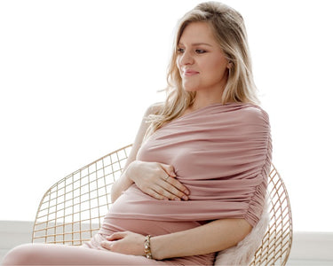 Image of a Pregnant Woman wearing a stylish pink maternity dress - this image is used on OleOle Home Page for Mum Essentials Collection - Explore must-haves for comfort and style