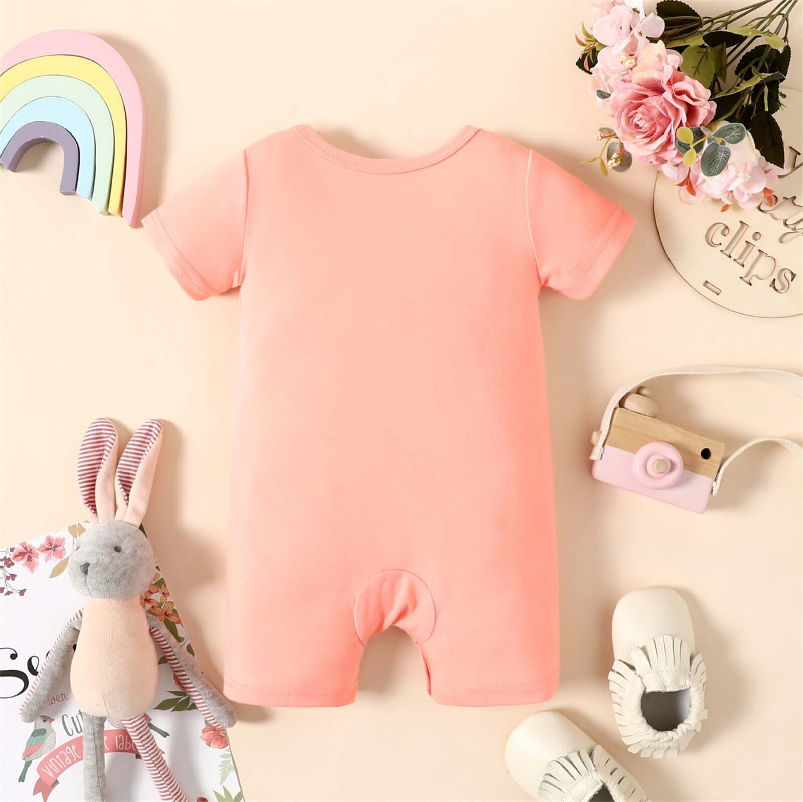 Image of adorable short-sleeve romper jumpsuit for newborn baby girls ages 0 to 18 months available at OleOle. A cute and comfortable outfit for your little one's first adventures.