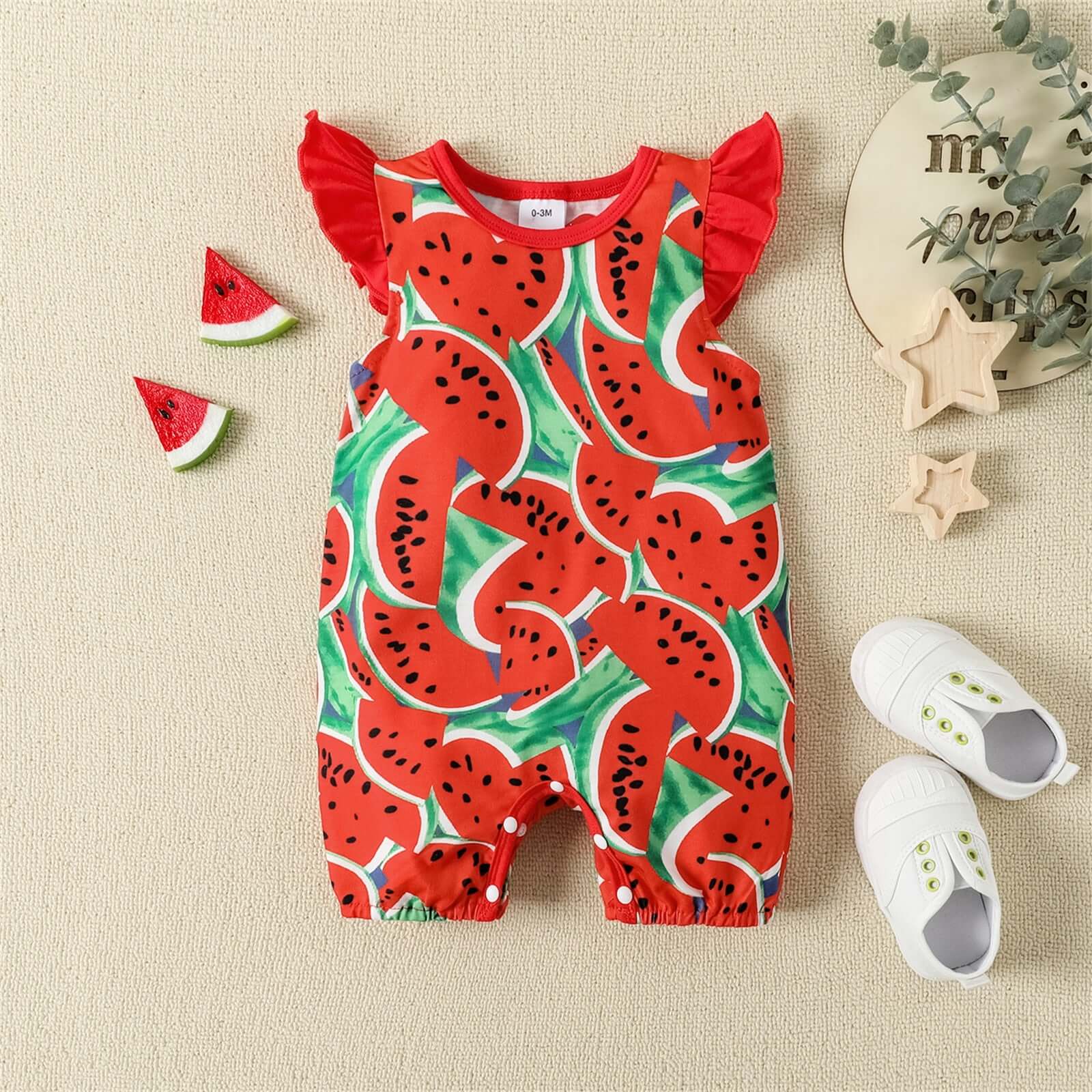 An image of a charming romper set for baby girls, featuring flutter sleeves and available in sizes from 0 to 18 months.